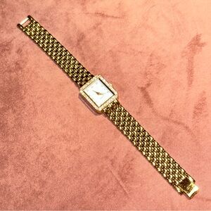 Mary Kay watch gold tones with stones on bezel and for numbers on face